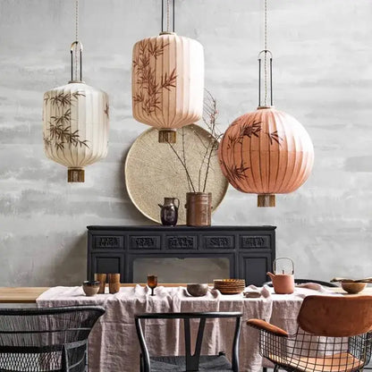 Three hanging cream and peach bamboo lantern pendant lights with bamboo leaf designs from decorbites bamboo lantern collection