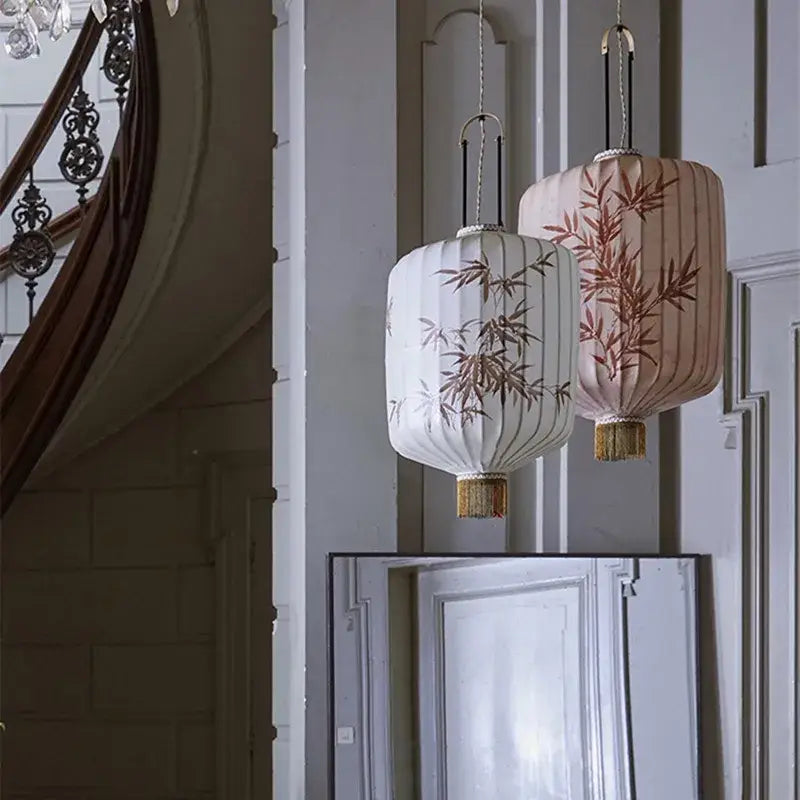 Two elegant decorbites bamboo lantern pendants in cream and peach with bamboo embroidery and golden tassels