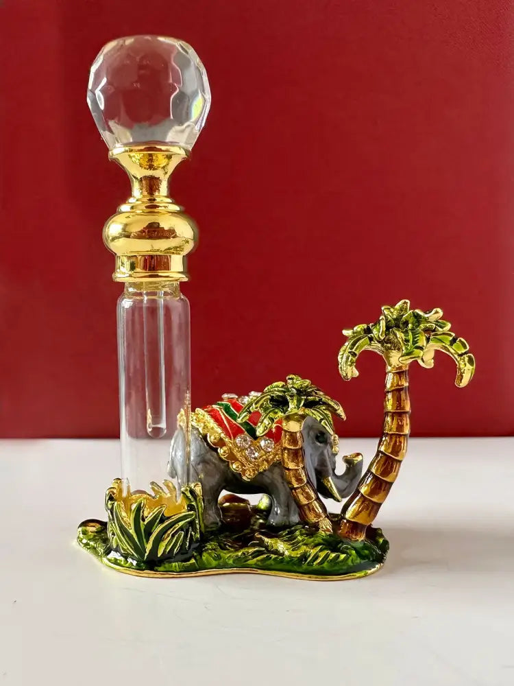 Handmade red and gold crystal perfume bottle with faceted stopper and elephant palm tree base for bedroom decor