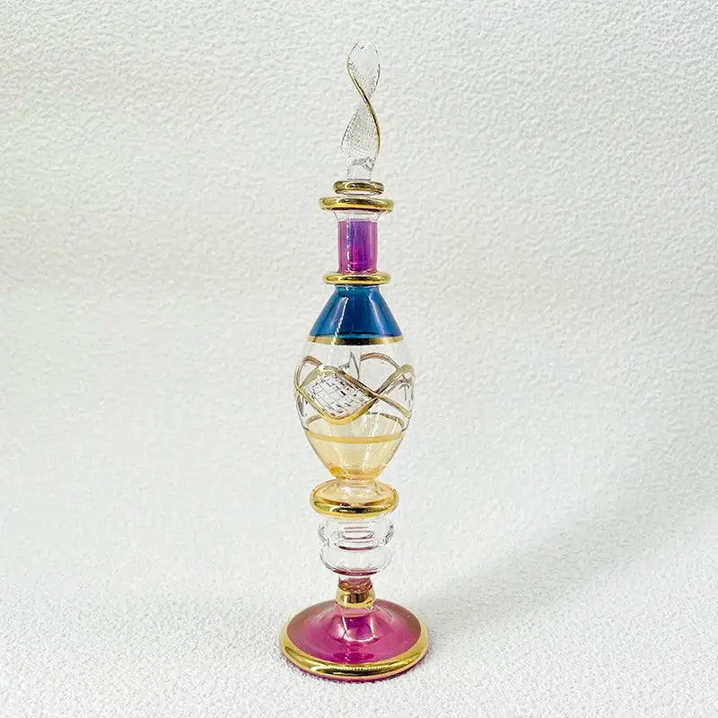 Handmade glass bottle with vibrant purple blue and gold accents and a twisted stopper as an exquisite ornament for living room decor