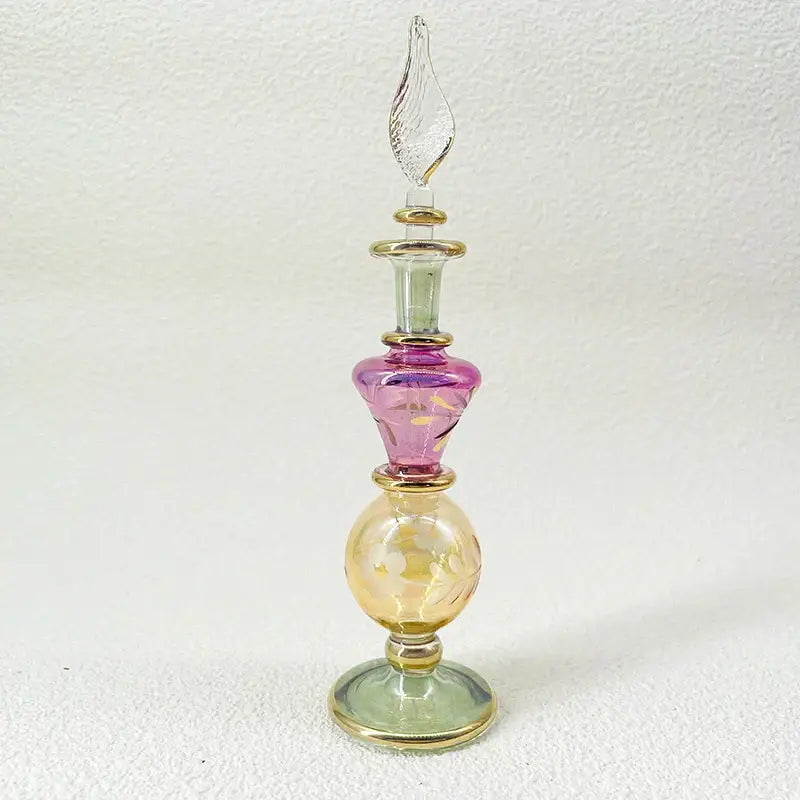 Slender multi-colored handmade glass bottle with gold stopper and metallic bands as an exquisite ornament for decor