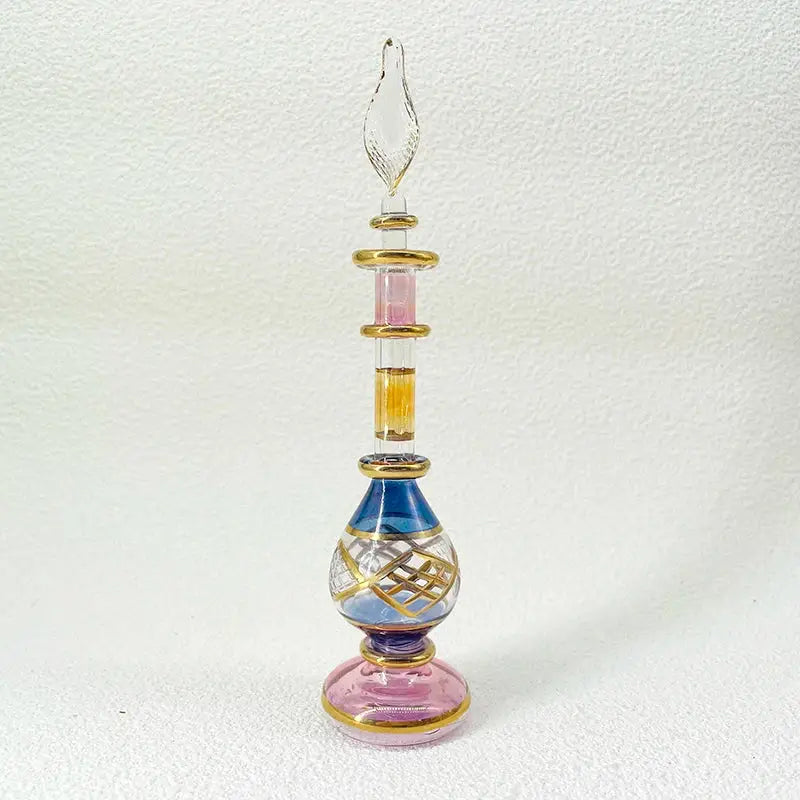 Slender handmade glass bottle with multi-colored design and gold accents as an exquisite ornament for living room decor