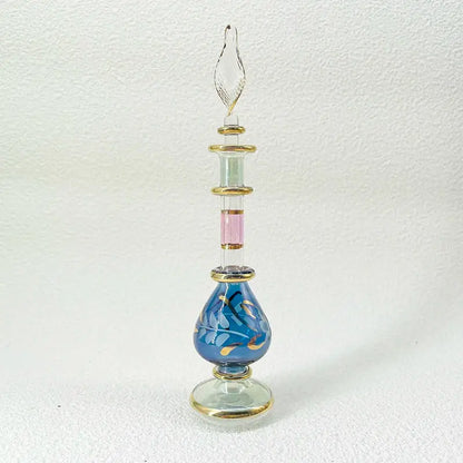 Slender handmade glass bottle with blue and gold leaf design and twisted stopper as an exquisite ornament for living room decor