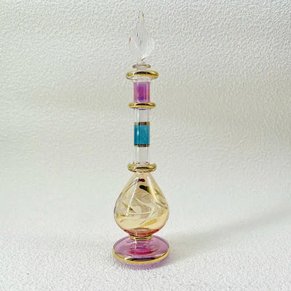 A slender handmade glass bottle with gold accents and a fluted stopper as an exquisite ornament for living room decor