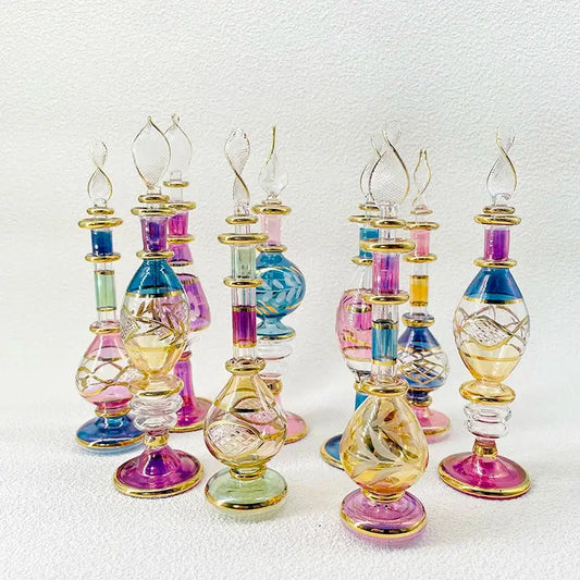 A collection of colorful handmade glass bottles with intricate cuts and gold accents as exquisite ornaments for decor