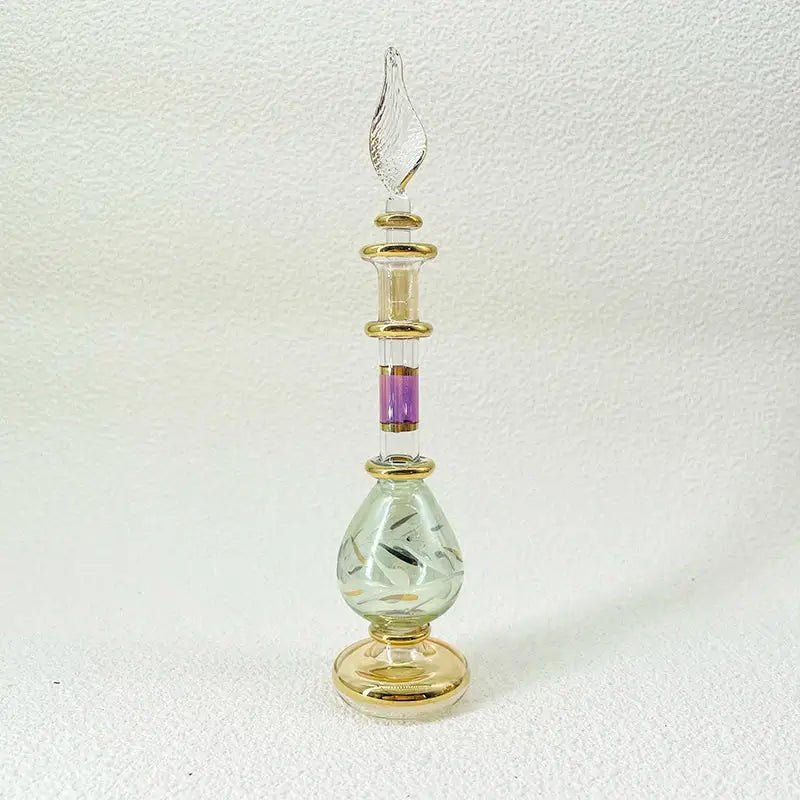 Elegant handmade glass bottle with gold accents and purple inlay, an exquisite ornament for living room decor