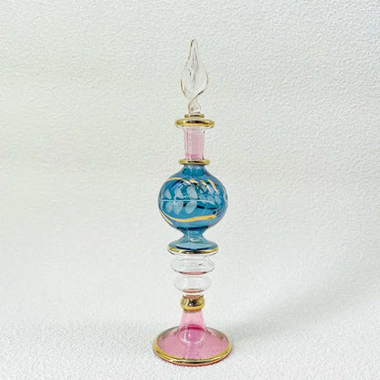 A delicate blue and pink handmade glass bottle with gold accents and a clear twisted stopper, an exquisite ornament for decor