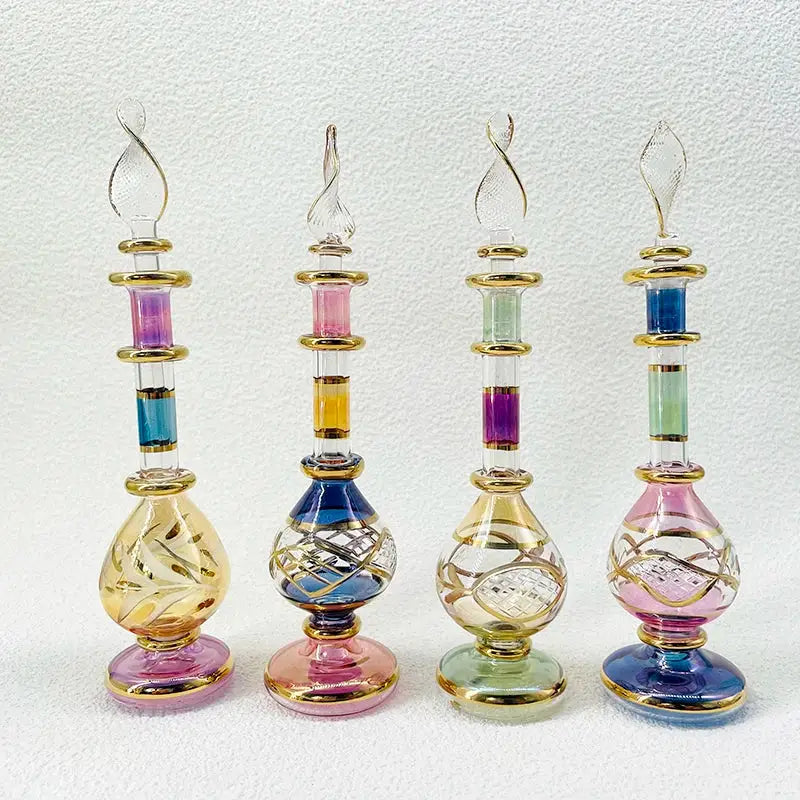 Four handmade glass bottles with gold accents and colorful stained glass as exquisite ornaments for decor