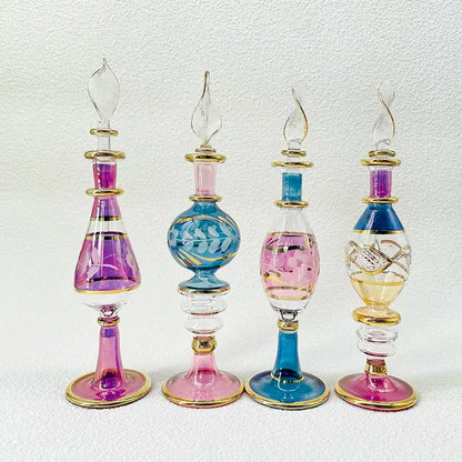 Four handmade glass bottles with gold accents in pink blue and yellow serve as exquisite ornaments for living room decor