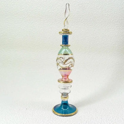 A tall handmade glass bottle with a blue base and gold accents as an exquisite ornament for living room decor