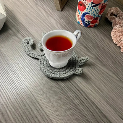 Handmade gray crocheted cat butt coaster showing back side in set of 4 for dining room decorbites cat butt coasters