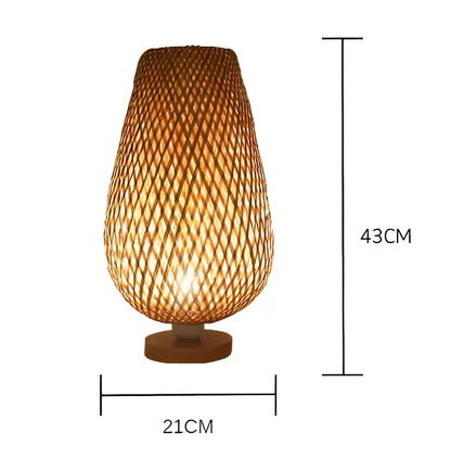 A warm-toned handmade bamboo table lamp with a tapered cylindrical shade and wooden base for bedroom use