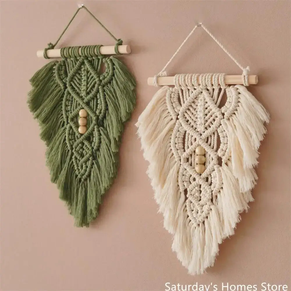 Two handmade macrame leaf wall hangings in olive green and cream white with wooden dowels and decorative beads for bedroom decor