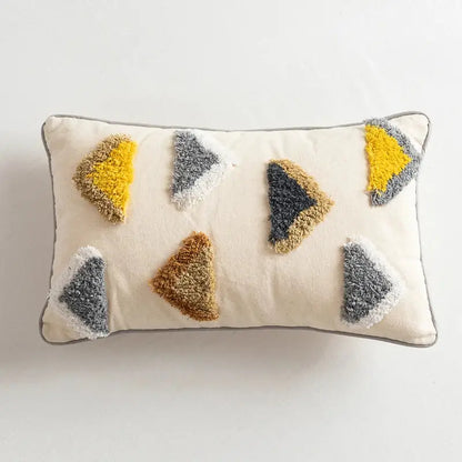 Cream-colored pillow cover with textured fuzzy triangular appliqués in yellow gray and brown for decorbites handmade moroccan geometric decor