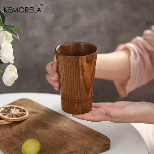 A warm brown handmade natural wooden tea tumbler with smooth polished finish and subtle vertical grooves for dining decorbites