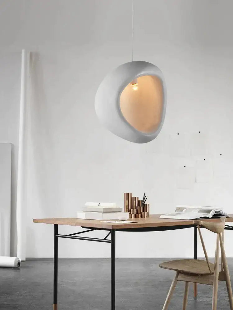 A sleek white handmade nordic designer chandelier ceramic pendant light with an open oval shape for dining room decor