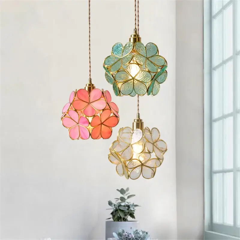 Handmade pink and teal glass petal pendant light with translucent floral petals and gold-toned metal frame hanging