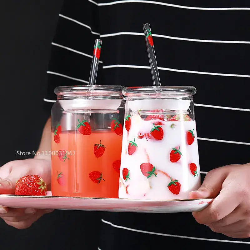 Handmade decorbites glass cup set with strawberry decals and matching straws filled with pink and white drinks