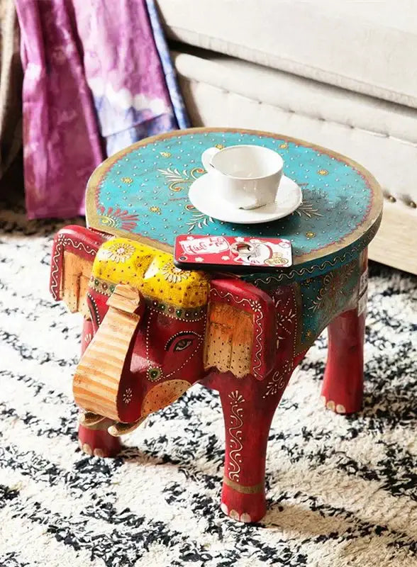 Handmade thai style decorbites elephant stool with turquoise top red legs and intricate gold yellow patterns for decor