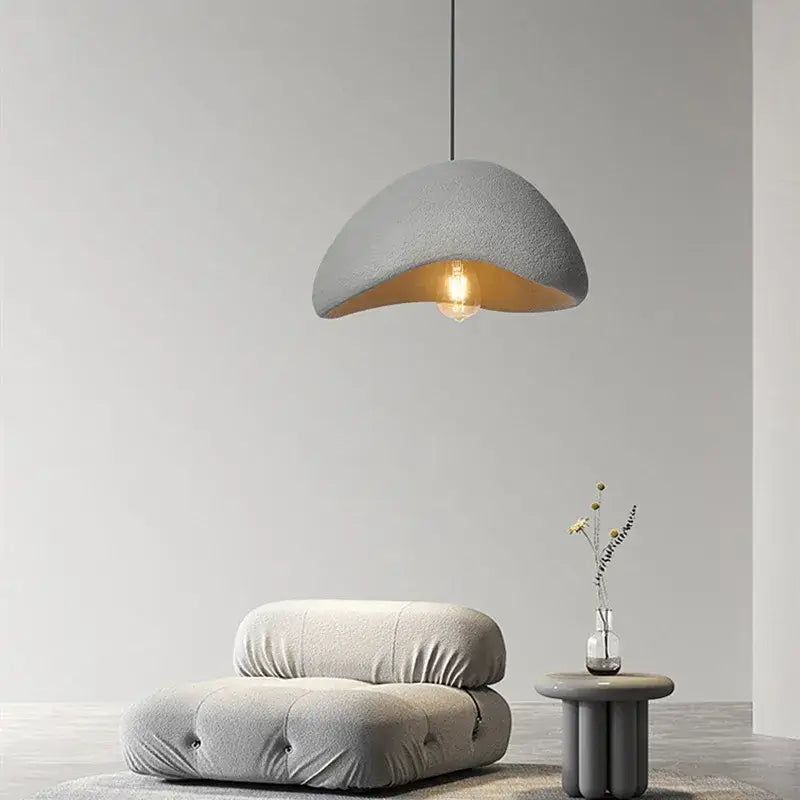 Gray textured half-moon pendant lamp with warm interior glow handmade wabi sabi decorbites dining room lighting