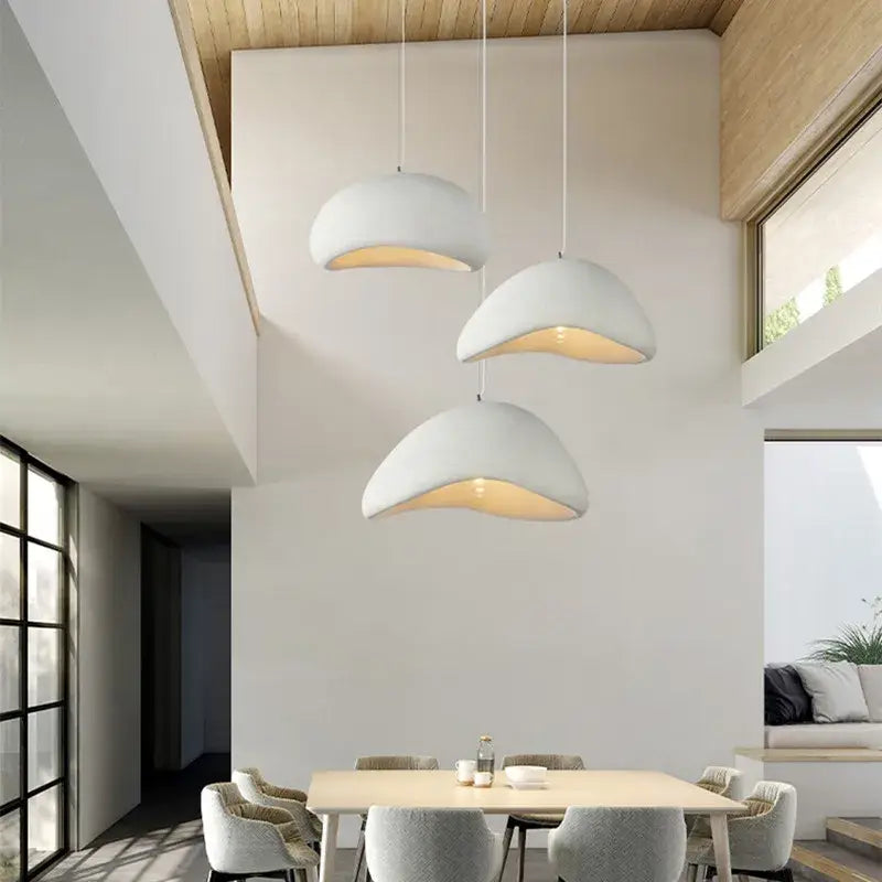 Three white dome-shaped pendant lamps with warm light handmade wabi sabi decorbites dining room lighting