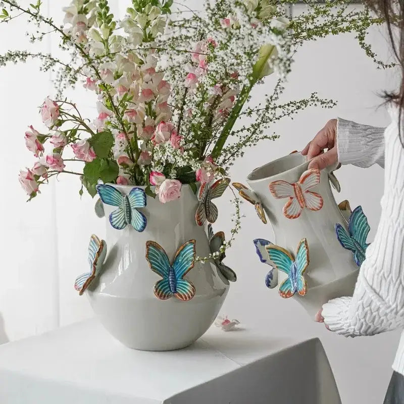 Handmade white ceramic butterfly vase with colorful three-dimensional blue teal and orange decorbites butterfly accents