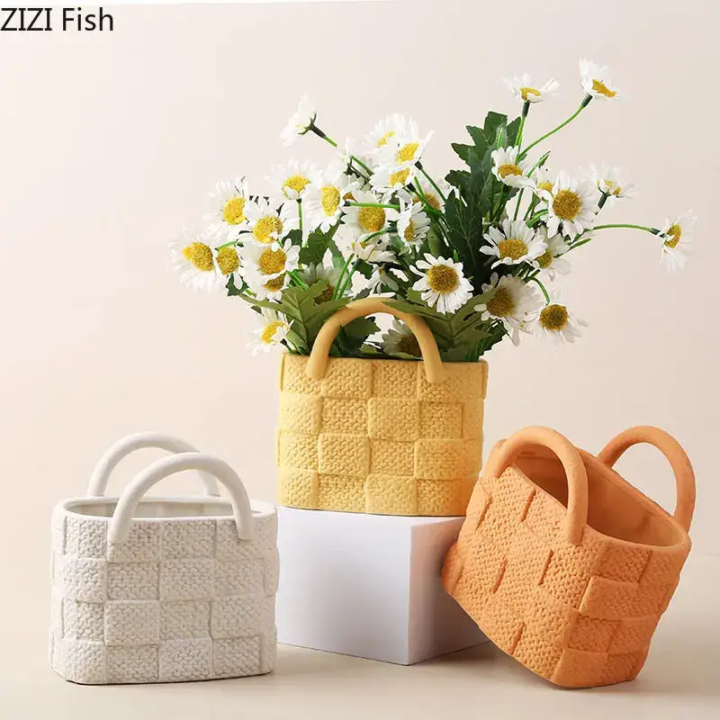 Yellow handwoven ceramic vase planter with white daisies in orange woven basket decorbites handwoven ceramic decor