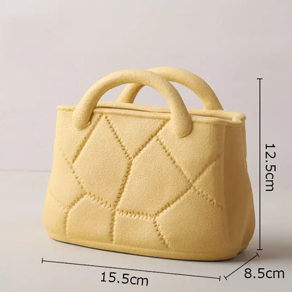 Pale yellow ceramic handbag with quilted diamond pattern and rounded handles as decorbites handwoven ceramic vase planter