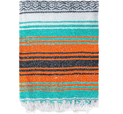 A decorbites handwoven mexican blanket with bold teal orange black stripes and white fringe ideal for bedroom decor