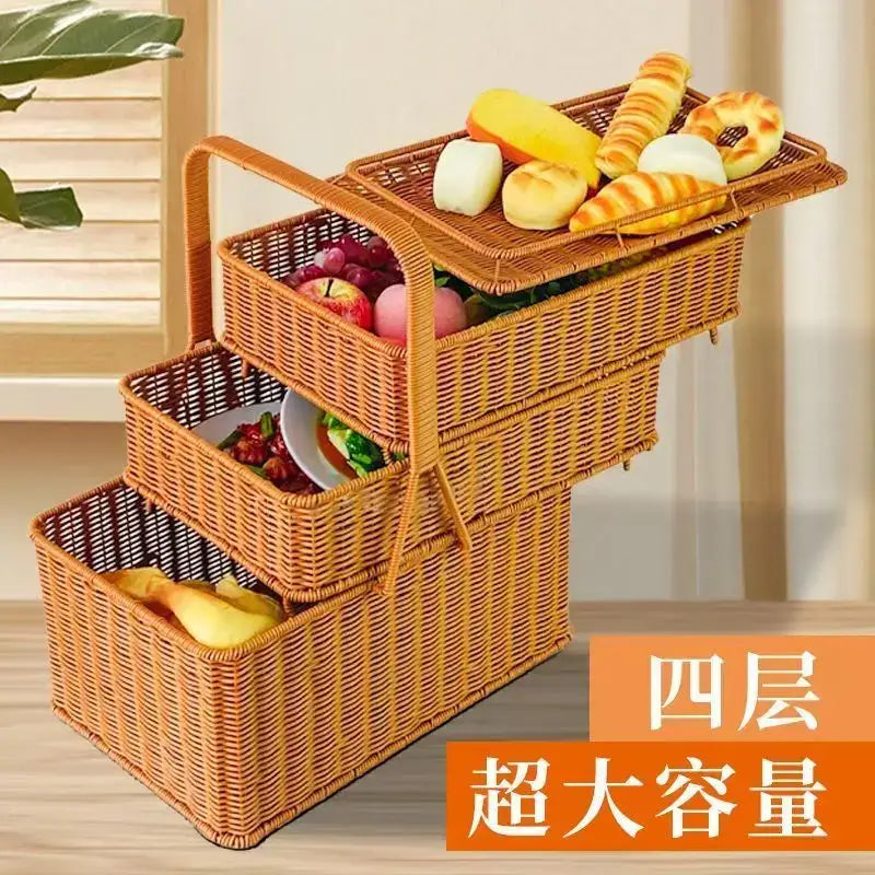 A four-tiered handwoven rattan picnic basket with natural brown wicker and stacked compartments for fruits and pastries