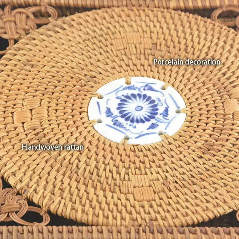 Handwoven rattan storage box with blue ceramic lid featuring a central blue and white porcelain placemat by decorbites