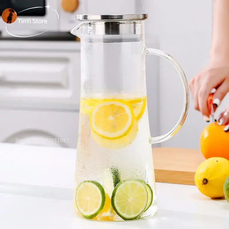 Clear glass pitcher water carafe with stainless steel lid and handle filled with lemonade slices for kitchen use