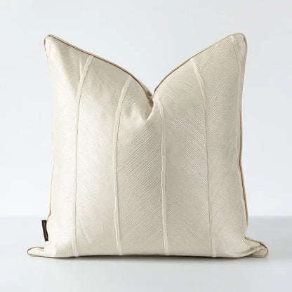 Cream-colored herringbone jacquard cushion cover with subtle textured weave and vertical stitched seams for living room decor