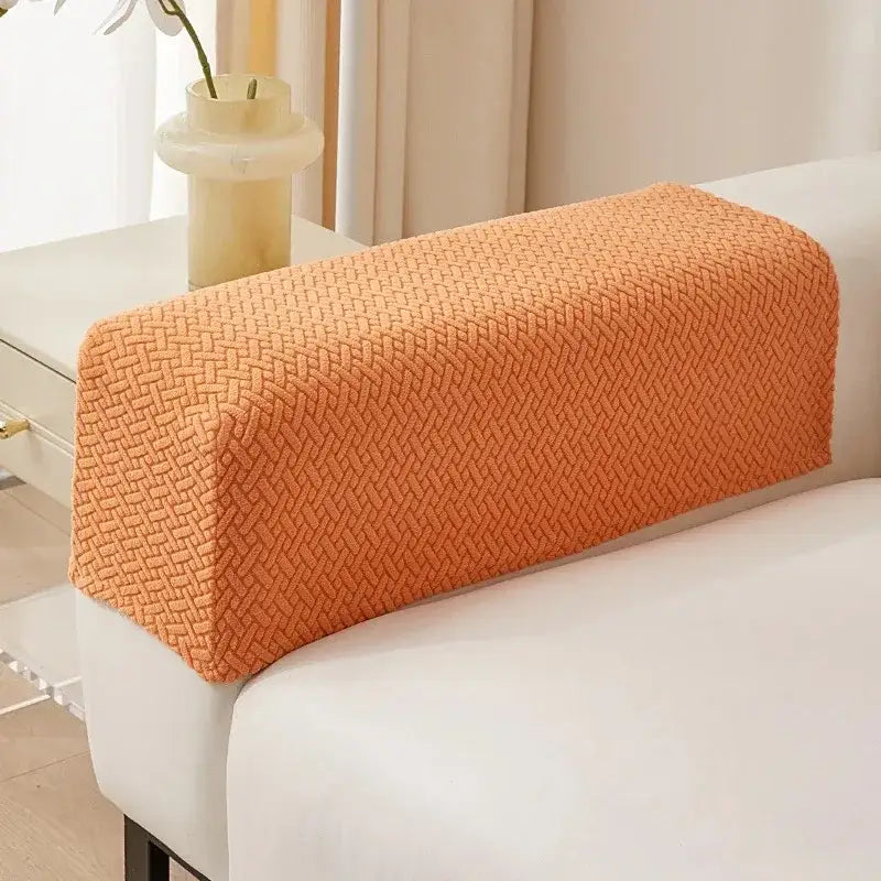 Orange herringbone weave fleece armrest cover protecting textured fabric sofa in living room setting