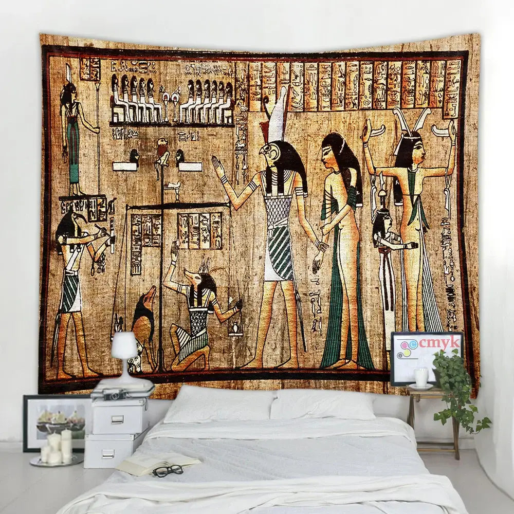 Earthy toned egyptian pharaoh mural tapestry with hieroglyphics hanging above a bed in hippie style bedroom decor