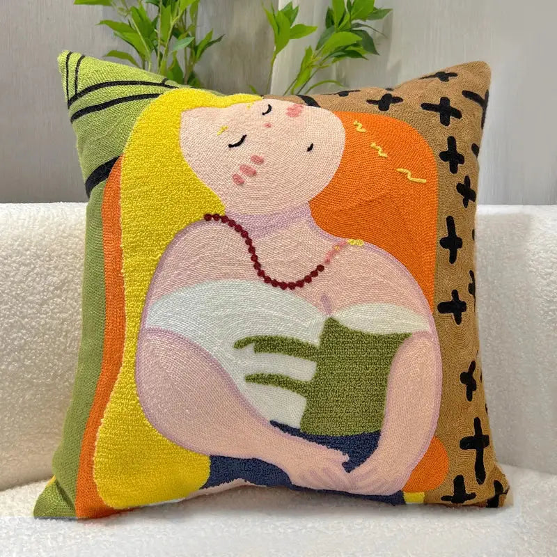 Vibrant embroidered throw pillow with cartoon oil painting embroidery of a sleeping woman holding a green book for living room decor