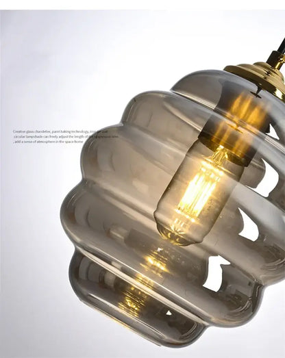 A modern honeycomb amber blue and gray glass pendant light with a warm glow for kitchen dining decorbites colorful glass