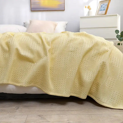 Soft pale yellow honeycomb waffle cotton throw blanket with textured waffle pattern for bedroom decor by decorbites