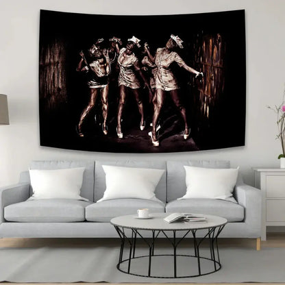 Black and sepia horror movie character tapestry featuring three dancers in metallic outfits above a gray sofa decorbites