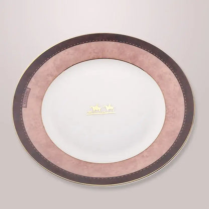 A delicate pink and brown decorbites bone china tableware set plate with gold trim featuring an elegant horse motif