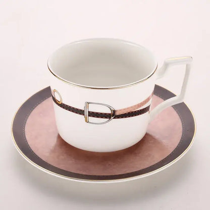 White porcelain espresso cup with brown leather strap and silver buckle on matching saucer from decorbites bone china tableware set