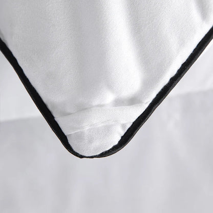 White cotton pillowcase with black stitched border paired with hotel style lightweight fluffy queen king comforter