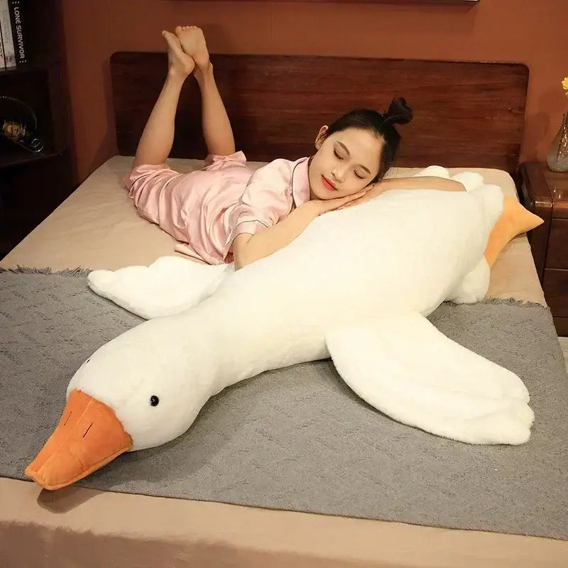 A plush white huge goose body pillow with orange beak and webbed feet made of soft fabric for bedroom decorbites huge goose decor