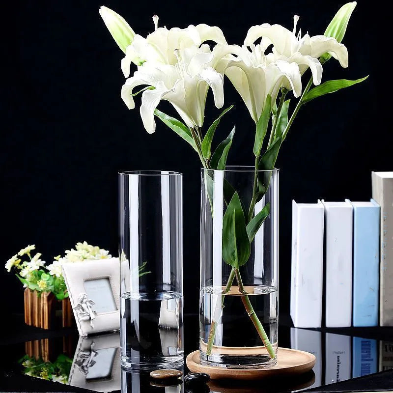 Clear cylindrical glass vase with white lilies and green stems for hydroponics plants desktop home decoration