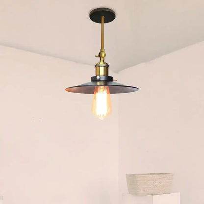 Industrial adjustable wall light with brass stem black matte shade and exposed Edison bulb for kitchen decorbites industrial adjustable