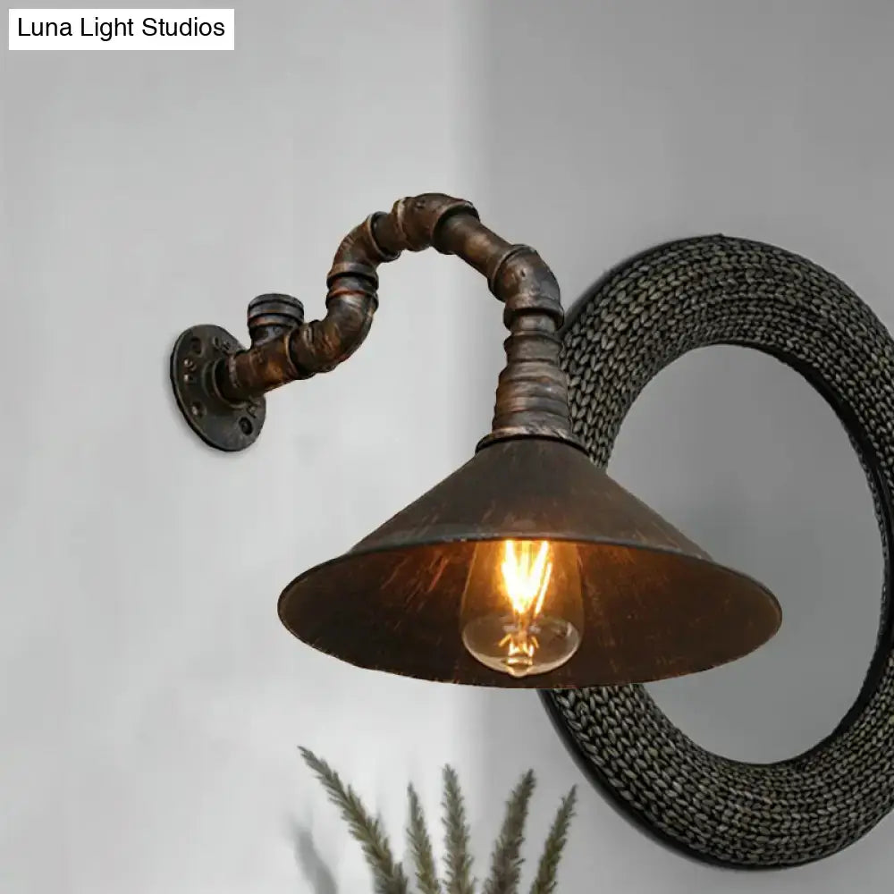 Decorbites™ farmhouse style wall sconce with antique brass cone and rusted metal pipe arm featuring exposed edison bulb