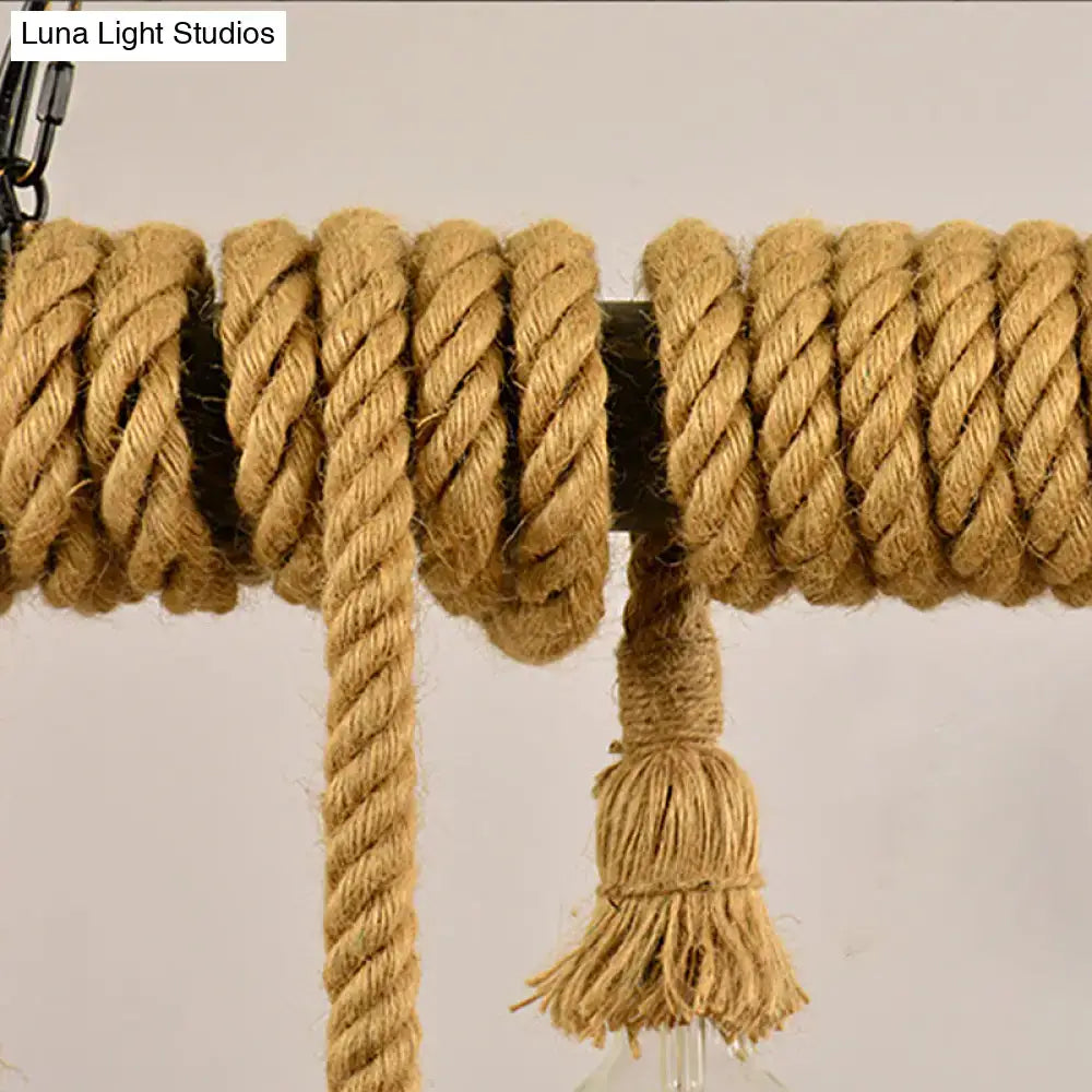 Coiled natural fiber rope in warm tan wrapped around dark metal rod with frayed tassel for decorbites industrial style hanging island light in dining room