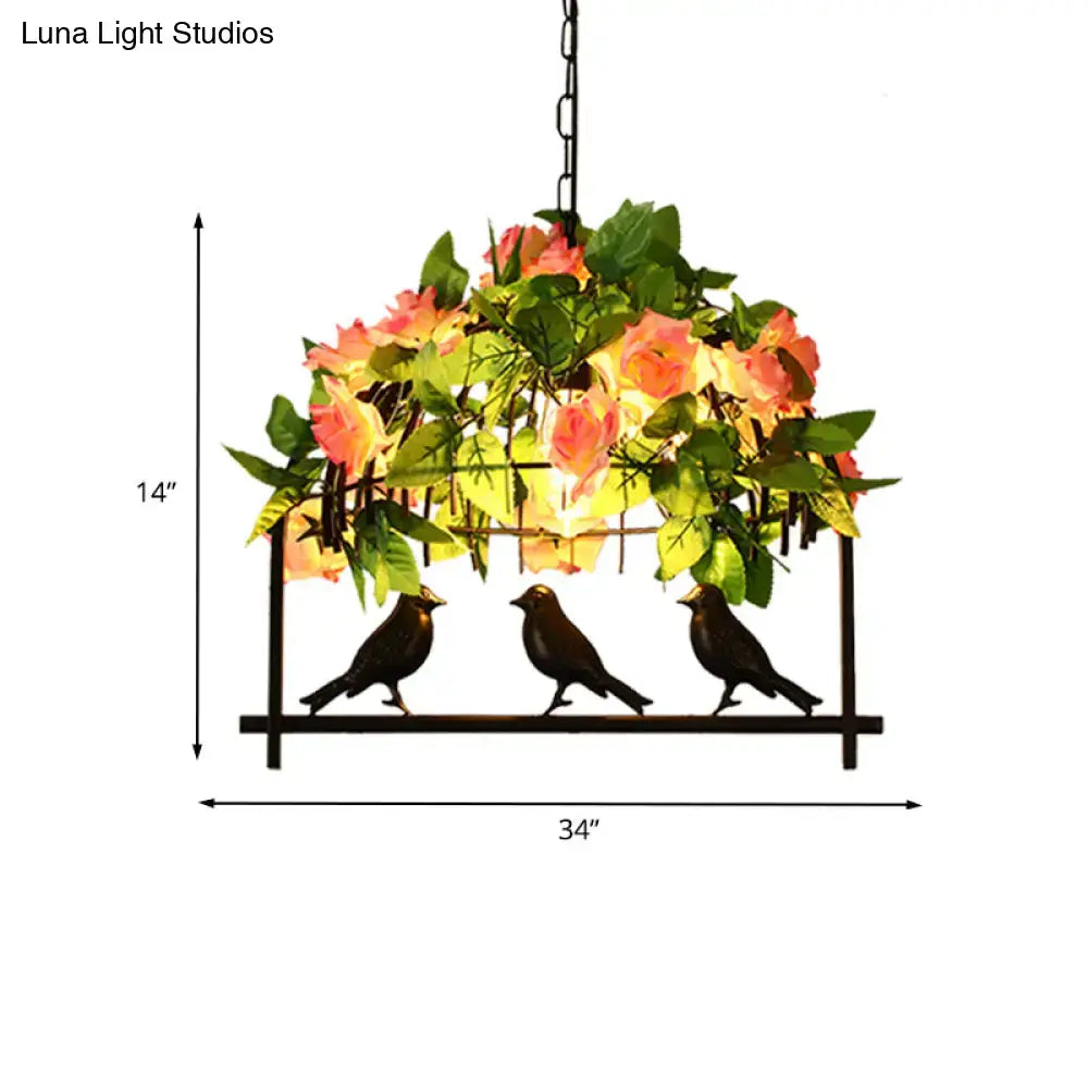 Black metal bird-themed industrial birdcage island pendant light with peach and green floral decoration on rectangular frame