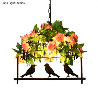 Black metal industrial birdcage island pendant with three birds and pink yellow rose cascade in iron black finish