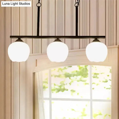 Black metal bar pendant light with three frosted opal glass globe shades perfect for dining rooms decorbites industrial lighting